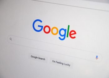Close-up of the Google homepage on a screen showing search options.