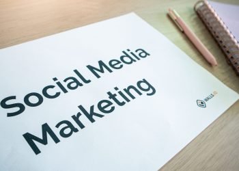 Close-up of a social media marketing document on a desk with a pen and notebook.